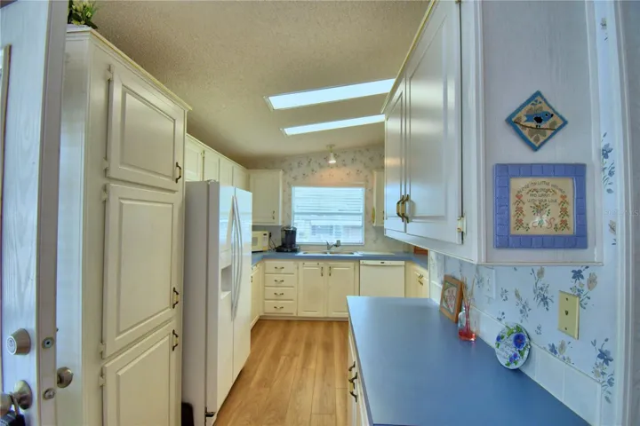 The kitchen has lots of counter space and cabinets.