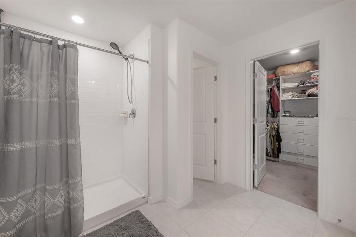 Primary bedroom space with walk in closet shown