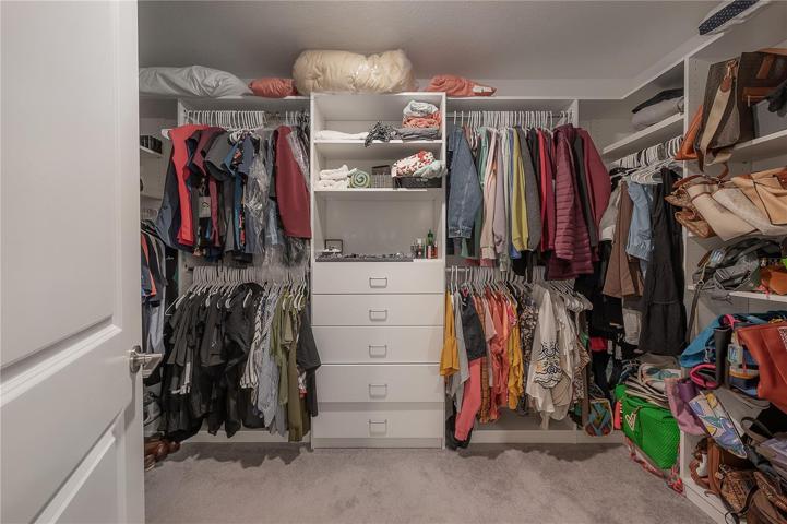 Primary closet has a custom closet system installed