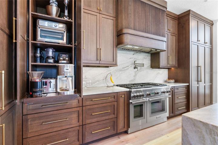appliance garage with coffee bar with pullout and electrical outlet to hide away the cords