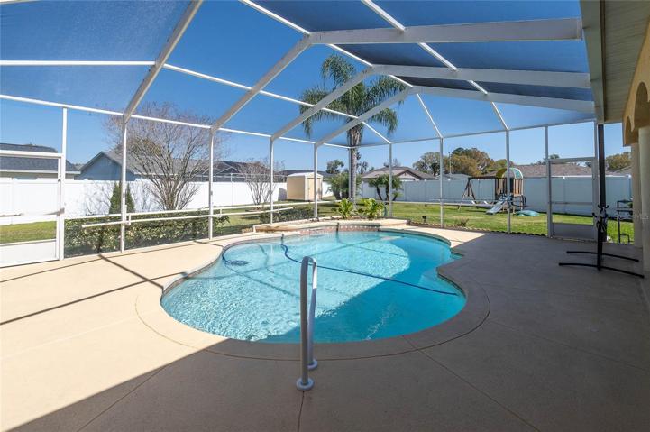 Pool with lots of room in the yard for play equipment and a shed to store items for yard work.