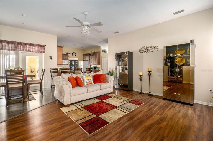 Family Room off the kitchen with doors to the lanai and pool area.