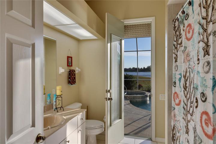 Guest bathroom leads directly to pool and spa.