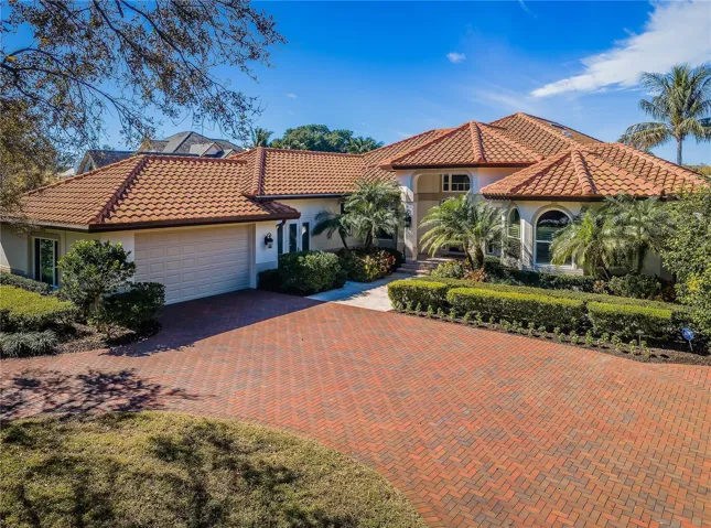 Gorgeous waterfront home with expansive brick paver circular-drive