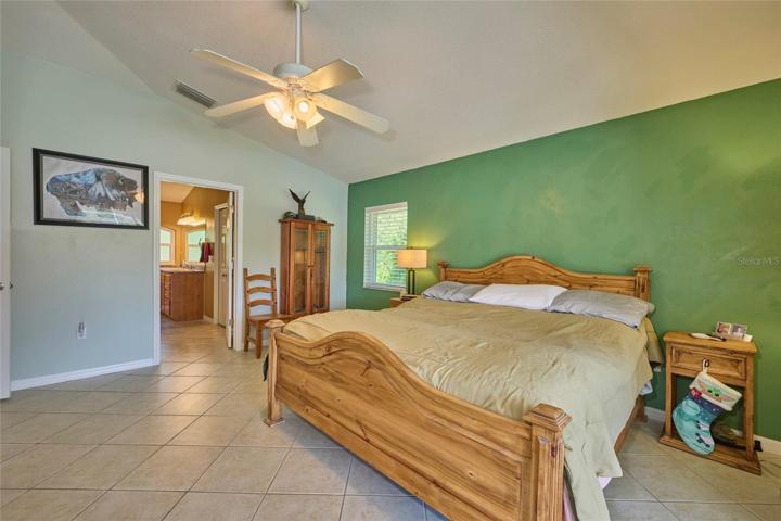 Reverse view of master bedroom with peek into master ensuite