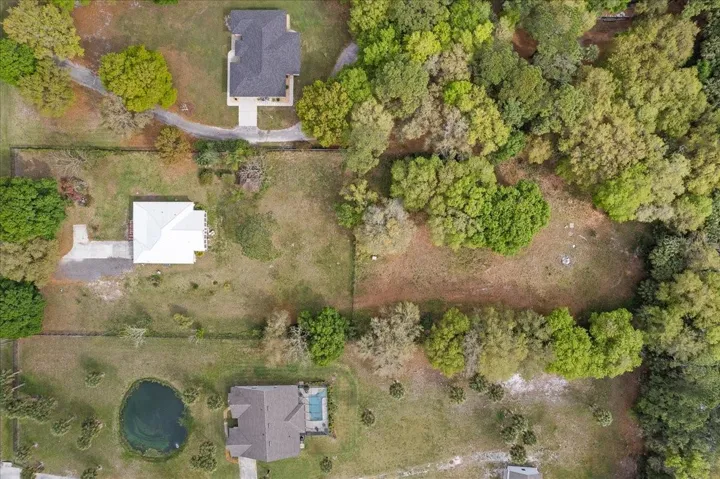 Aluminum fence enclosing approx. 1/5 acres shwoing remaining acreage in the back of the property