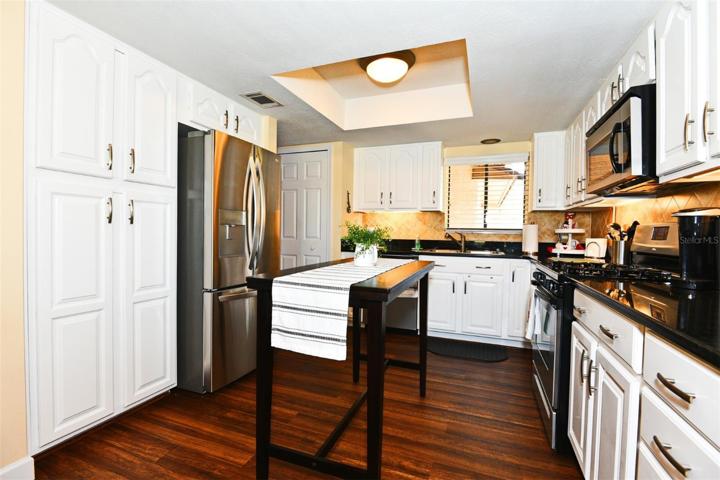 Granite Kitchen with Ample Storage Cabinets and Counter Space