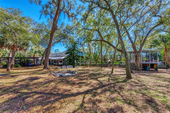 View from the other side of the yard, looking at the gazebo/Zen Den, fire pit, and north side of the main house