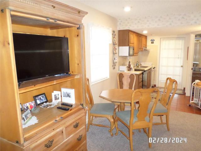 Armoire with TV and dining area seating for 4