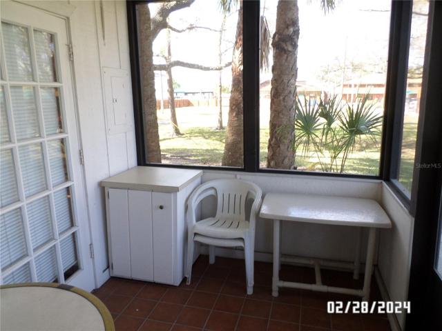View 2 of back porch with additional patio furniture