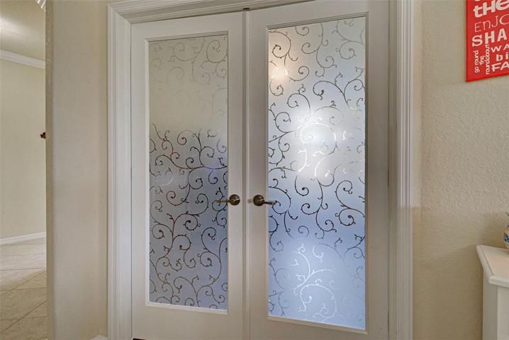 The office has beautiful glass doors which open to the home or close when you need the privacy, adding a touch of decor to the home.