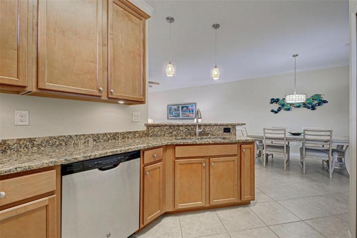 Granite counters and stainless steel appliances complete the look of the modern kitchen.