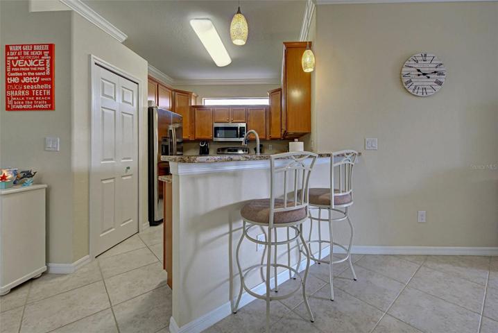 The galley kitchen with pantry has beautiful cabinets and plenty of storage space.