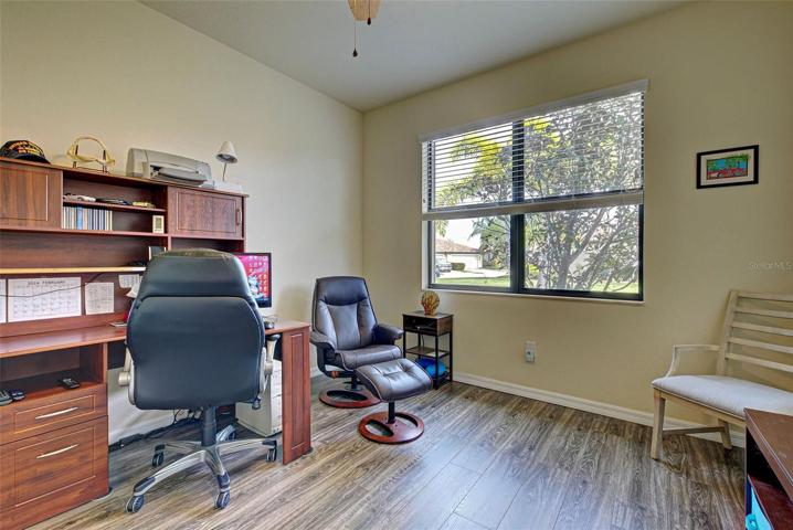 A large window in the office lets the sun in and brightens the room.