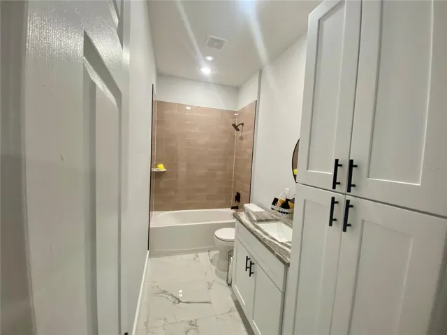 hall bath with storage cabinet
