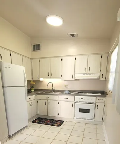 Lots of cabinet space in your Kitchen! Tile floors and natural light
