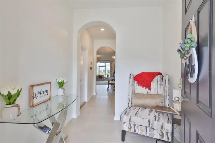 MOVE-IN READY - Front foyer entrance with seating area to read a good book while waiting to greet guests.