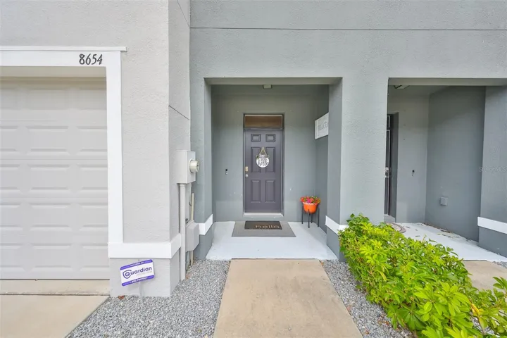WELCOME! Enter this front door entrance with patio perfect for seating and watching the world go by.