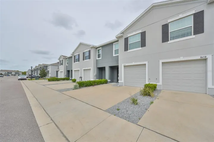 Gated community offers privacy and security as you enter the front entrance driveway with garage.