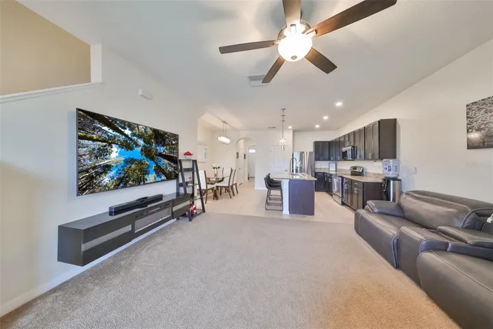 Large open family room leads up to the staircase to the additional bedrooms.