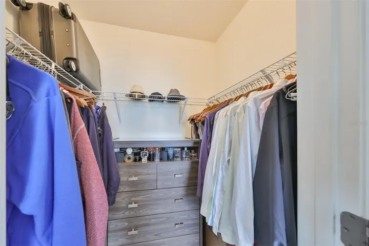 ONE of TWO walk-in closets in the primary bedroom.
