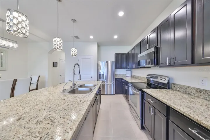 Recessed lighting along with pendant lighting makes for a bright open space.