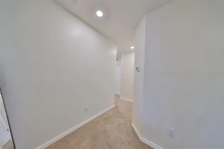 Brightly Lit upstairs hallway which leads to bedrooms - Primary Bedroom to the far right and Laundry nook and two secondary bedrooms are straight ahead.