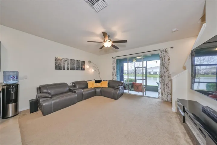 Large living room space makes sure that everyone has room to stretch out with sliding doors that lead onto the screened patio and water view.