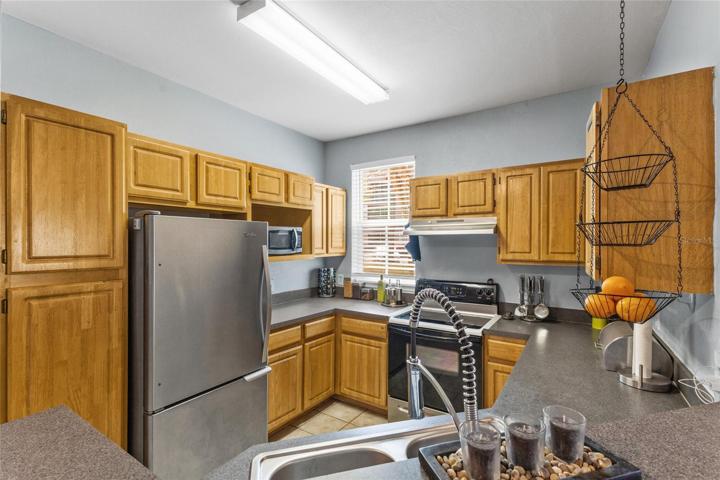 Kitchen sink features goose-neck faucet