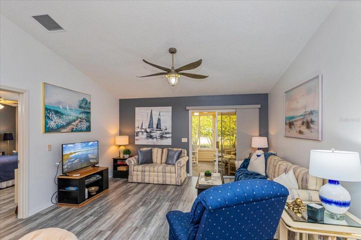 Living Room Opens to Kitchen/Dining & Enclosed Lanai