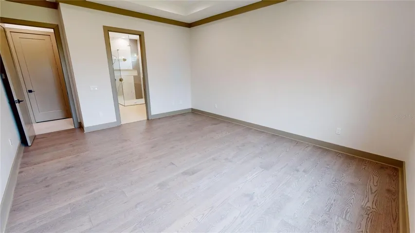 Primary bedroom with view of bath