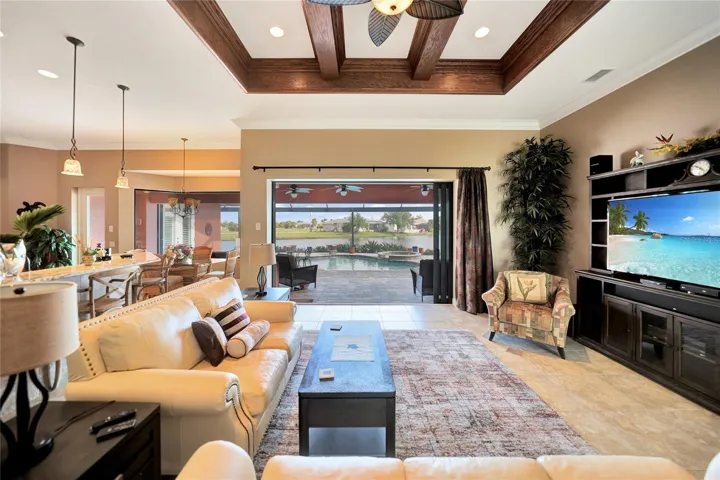 Living room with the open sliders. Beautiful pool & lake view