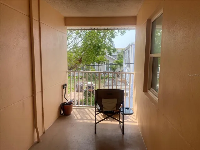 View just outside your front door, facing south. There is an AMAZING breeze in this area. You can see the water from the railing, looking left.