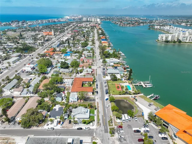 "C' shaped building with red tile roof, with the pool & dock across the street. The building on the bottom right is the St Pete Beach Community & Aquatic Center.