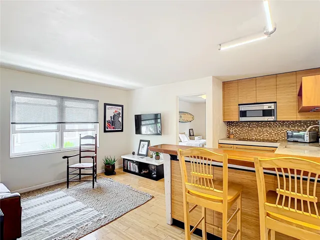 At the front door looking in. View of living room and kitchenette. Bamboo flooring through-out the living areas. Updated Windows.