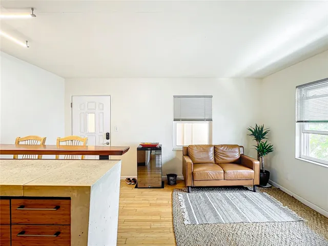 Another view of the living room. Here, please note the unique design of the counter as it flows down the side of the custom made bamboo cabinets.