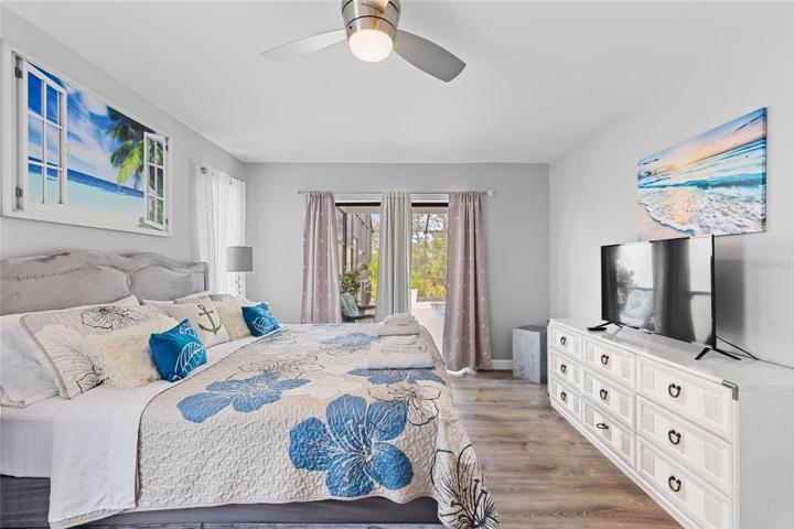 Master bedroom with pool access and private outdoor sitting area
