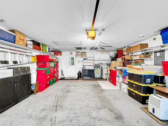 Large garage with shelving for storage.