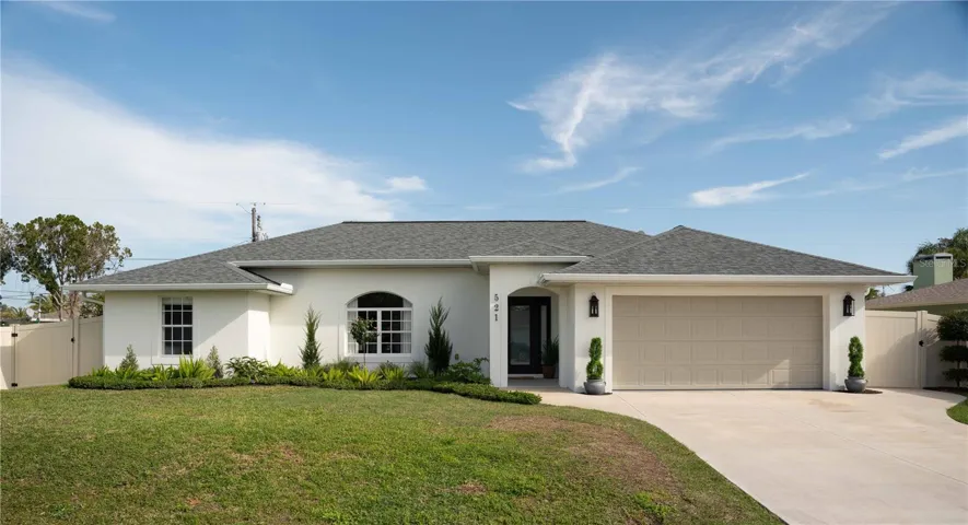 Charming exterior painted warm white, blending tradition and current contemporary style. The entry arch is repeated in the interior.