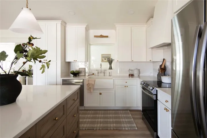 Rohl bridge faucet with a side spray in polished nickel is likened to jewelry and adds a touch of elegance. Under sink is InSinkErator Evolution Compact 3/4 HP Continuous Feed Garbage Disposal and Coregaurd sink base.