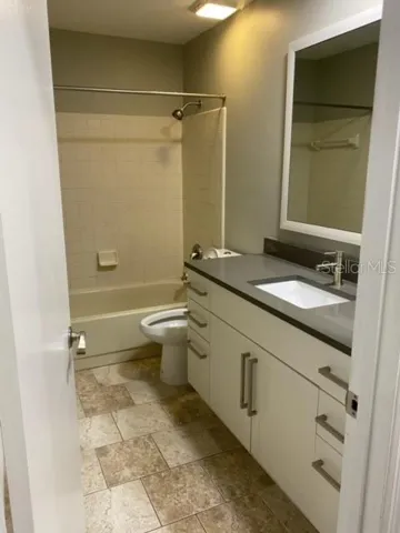 Large bathroom with contemporary wooden vanity and quartz top