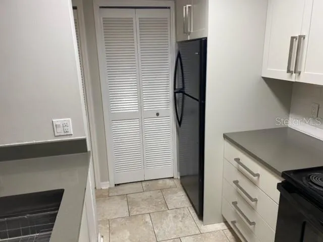 White wood cabinet with grey quartz tops