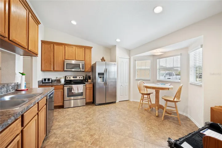 Looking into the kitchen and nook area just to the right of the front entry