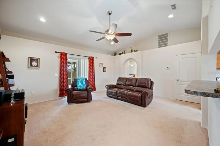 Looking into the large great room with kitchen serving bar to the right