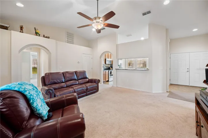 Large great room looking at the kitchen serving bar and the double entry way