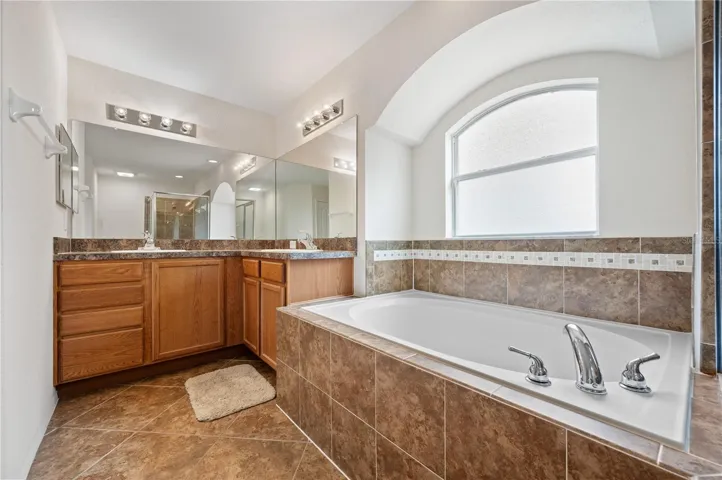 Dual sinks and garden tub in primary bathroom