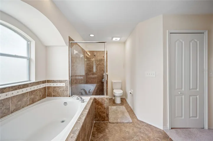 Garden tub and walk in shower in primary bathroom
