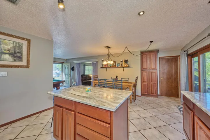 Kitchen with peek into family room and living room.  Door to back right leads into laundry room.