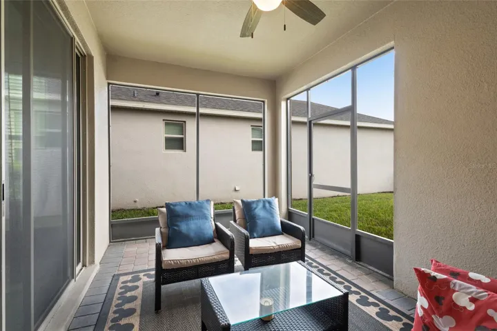 Lovely screened covered patio with ceiling fan.