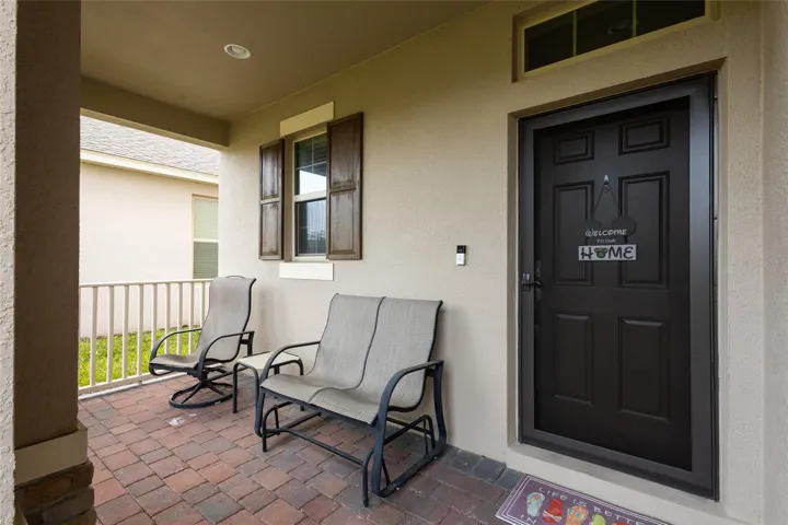 Lovely covered front porch overlooking the greenspace.